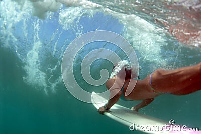 Teen Bikini Surfer Duckdiving Stock Photo