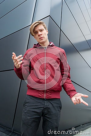 Teen boy gesticulating to express doubt about decision Stock Photo