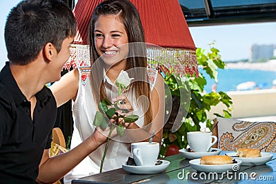 http://thumbs.dreamstime.com/x/teen-boy-giving-flower-to-girlfriend-restaurant-young-men-girl-coffee-date-34138237.jpg