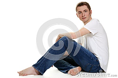 Teen boy in jeans sitting Stock Photo