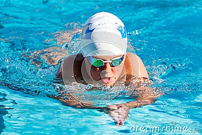 Teen boy swimming breaststroke. Stock Photo