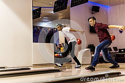 Teen boys bowling together at once Stock Photo