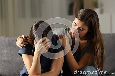 Teen comforting hes sad friend in the night Stock Photo