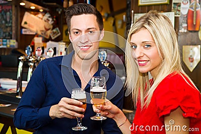 Teen couple drinking beer at the pub Stock Photo