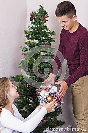 Teen couple near Xmas tree Stock Photo