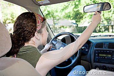 Teen Driver Adjusting Rearview Mirror Stock Photo