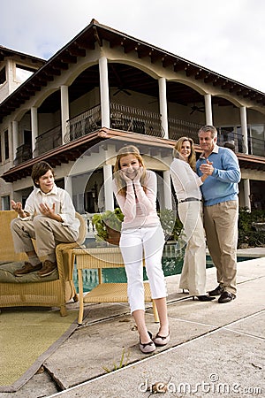 Teen girl amused by parents dancing Stock Photo