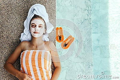 Teen girl applying organic fruit facial mask Stock Photo
