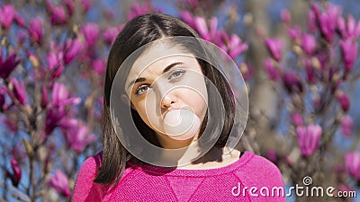 Teen girl blowing bubblegum bubble Stock Photo