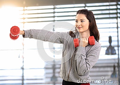 Teen girl boxing with hand barbell Stock Photo