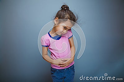 Teen girl child stomach ache on gray background Stock Photo