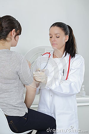 Teen girl complaining to mature doctor about symptoms malaise Stock Photo