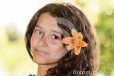 Teen girl with curly dark hair on nature Stock Photo