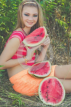 Teen girl is eating watermelon in green park Stock Photo