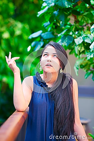 Teen girl with exasperated expression, looking up eyes rolled Stock Photo