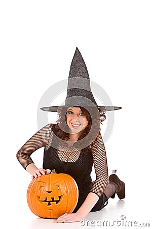 Teen girl in Halloween hat with carved pumpkin Stock Photo