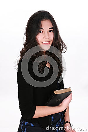 Teen girl holding Bible Stock Photo