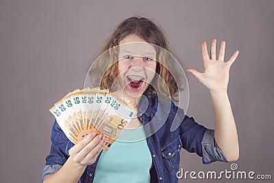 Teen girl holds in her hand euro Stock Photo