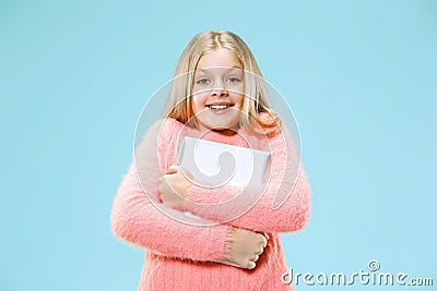 Teen girl with laptop. Love to computer concept. Attractive female half-length front portrait, trendy blue studio Stock Photo