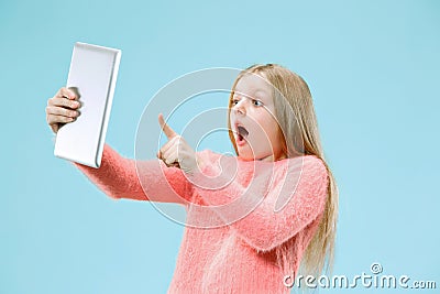 Teen girl with laptop. Love to computer concept. Attractive female half-length front portrait, trendy blue studio Stock Photo