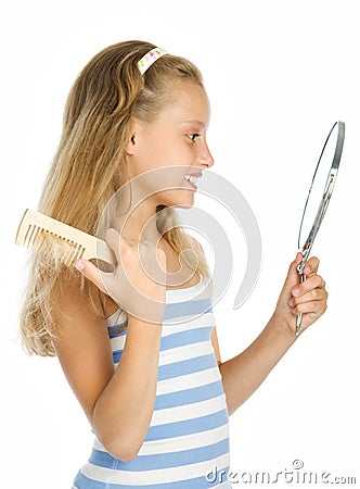 Teen girl look in to mirror and combing Stock Photo