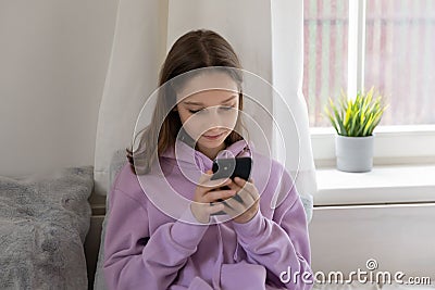 Teen girl obsessed with smartphone social media apps at home Stock Photo