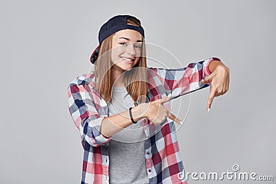 Teen girl pointing down at empty copy space Stock Photo