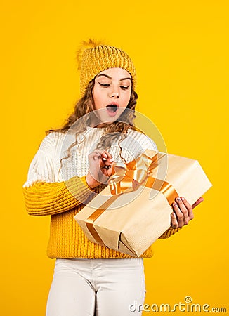 Teen girl received holiday gift. Best christmas gifts. Child excited unpacking gift. Kid little girl hold gift box with Stock Photo