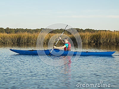 Teen girl sea kayaking Stock Photo