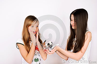 Teen girl shows her friend a lot of bottles of nail polish Stock Photo