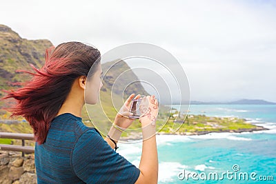 Teen girl standing above tropical Hawaiian ocean scenery Stock Photo