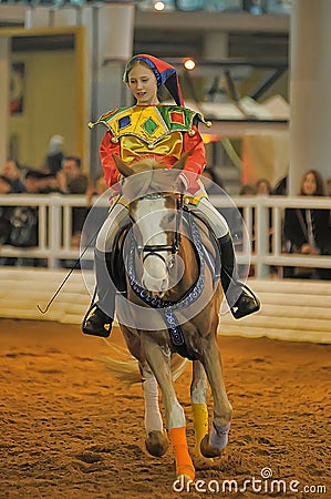 Teen girl in a suit buffoon on a horse Editorial Stock Photo