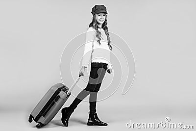 teen girl with suitcase for trip on yellow background, adventure Stock Photo