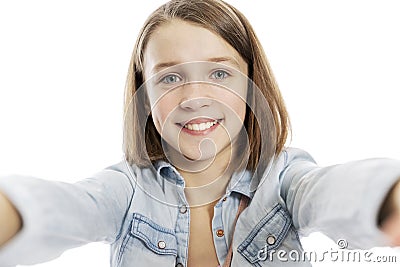 Teen girl takes pictures of herself, close-up. Isolated on a white background Stock Photo