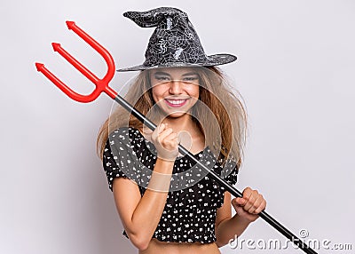 Teen girl in witch black hat Stock Photo