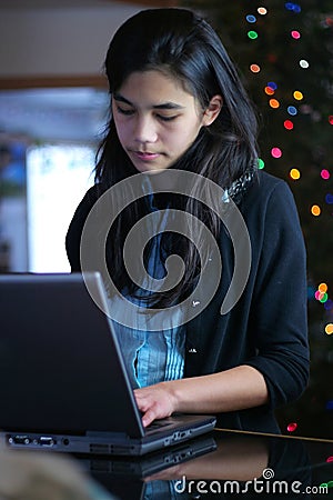 Teen girl working on laptop Stock Photo