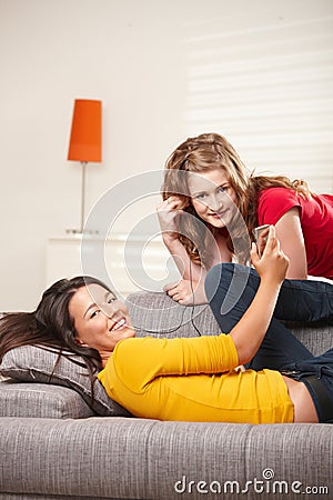 Teen girls listening to music at home Stock Photo