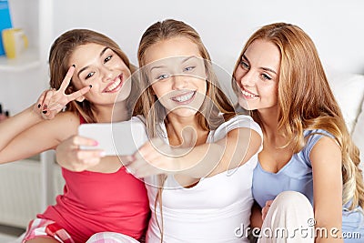 Teen girls with smartphone taking selfie at home Stock Photo