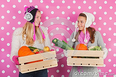 Teen girls with vegetables in winter Stock Photo