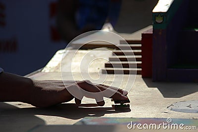 teen hand playing the fingerboard. freestyle and hurdles. Finger skateboard fingerboard mini skate, selective focus. home games in Stock Photo