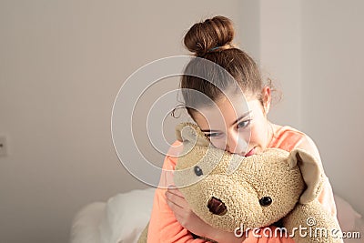 Teen hugging her teddy bear Stock Photo