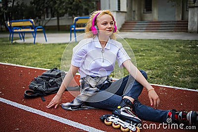 Teen Music And Happy Mood. Adolescent Music In Headphones. Cheerful Happy Girl Outdoor. Stock Photo