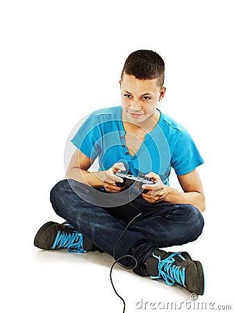 Teen plays on the joysticks sitting on the floor Stock Photo