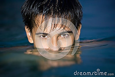 Teen in pool, having plunged on eyes into water Stock Photo