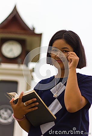 Teen reading clock tower. Stock Photo