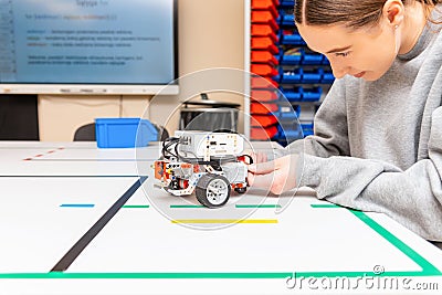 Teen student with diy robot on stem education class.Fixing mechanic toy car.Teen scientist working on new project.Stem education Stock Photo