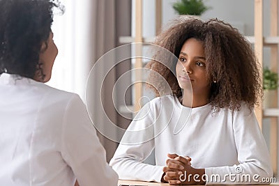 Teen visiting clinic listening medical worker sitting at doctors office Stock Photo