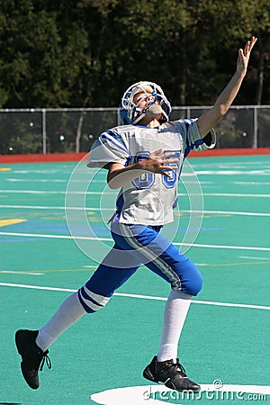 Teen Youth Football Player to Catch the Ball Stock Photo