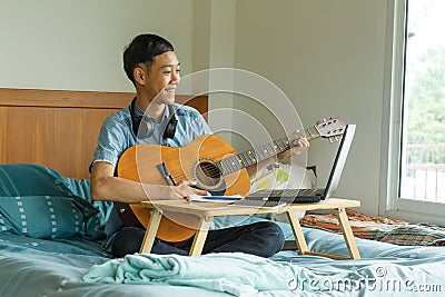 Teenage of asian boy learning guitar Stock Photo