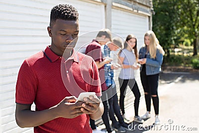 Teenage Boy Being Bullied By Text Message Stock Photo